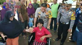 Terlihat Shinta tersenyum sumringah setelah diberi bantuan kursi roda oleh Kapolres Lumajang.