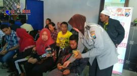 Anggota Polisi Wanita saat membagikan snack kepada masyarakat 