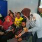 Anggota Polisi Wanita saat membagikan snack kepada masyarakat 
