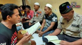 Tampak anggota Satbinmas Polres Sampang berbaur dengan para tahanan sembari membaca ayat suci Al-Qur'an. 