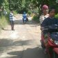 Terlihat beberapa pengendara melintas menghindari jalan yang rusak dan berlubang.