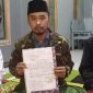 Sekretaris Himaka, Ustadz Ahya' (tengah) saat menunjukan surat pernyataan pertama yang dilakukan S yang diduga pemilik akun Alby Madura 