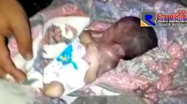 Tampak bayi sudah dalam keadaan meninggal dunia terbungkus kain dan menggunakan popok bayi.