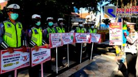 Satlantas Polres Pamekasan berjejer rapi dengan memegang papan bertuliskan imbauan Covid-19, saat  menggelar Operasi Zebra Semeru 2020.