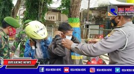 Polres Pamekasan bersama tim gabungan saat membagikan masker kepada pengguna jalan yang melintas selama PPKM.