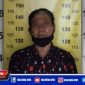 Tersangka (SH) saat diamankan di Mapolsek Tegalsari Surabaya.