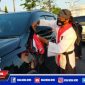 Ketua umum perguruan pencak silat Surban Putih saat mengikatkan bendera merah putih ke kendaraan.