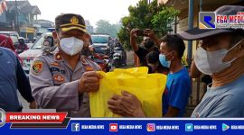 Kapolsek Krembangan (Kompol Redik Tribawanto) saat membagikan sembako kepada warga.