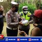 Caption: Kasat Lantas Polres Sampang (AKP. A. Nasution) saat membagikan nasi bungkus kepada korban banjir di Desa Banyumas.