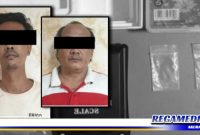 Caption: dua tersangka inisial (EY) dan (TDK) serta barang buktinya saat diamankan di Mapolres Pelabuhan Tanjung Perak Surabaya.