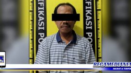 Caption: tersangka kasus penggelapan sepeda motor wartawan saat diamankan di Mapolsek Bubutan Surabaya.