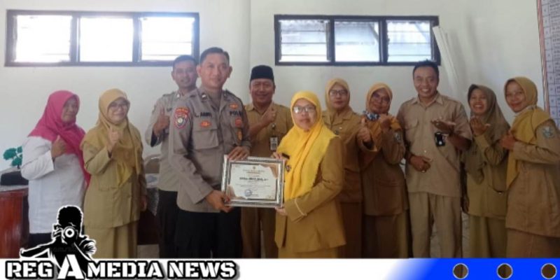 Caption: Aipda Liwail Amri, anggota Satbinmas Polres Sampang saat menerima reward dari Kepala SLBN Sampang, (dok. regamedianews).