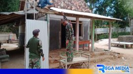 Caption: personel Koramil 0828/03 Omben tampak melakukan tahap pemasangan atap plafon rumah, (dok. regamedianews). 