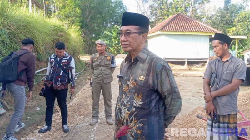 Caption: Bupati Pamekasan KH Kholilurrahman, meninjau langsung pengerjaan renovasi jalan swadaya, (dok. regamedianews). 