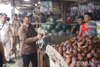 Caption: Bupati Bangkalan Lukman Hakim, meninjau dan menyapa langsung pedagang di kawasan Bancaran, (dok. regamedianews). 