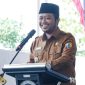 Caption: Wakil Bupati Sampang KH Ahmad Mahfud, saat mengisi sambutan dalam acara launching SPPG di Desa Taddan, (dok. regamedianews). 