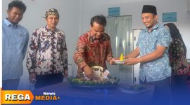 Caption: Bupati Bangkalan Lukman Hakim potong tumpeng sebagai tanda diresmikan dan launching SPPG Campor,  (dok. Syafin Rega Media). 