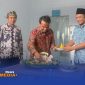 Caption: Bupati Bangkalan Lukman Hakim potong tumpeng sebagai tanda diresmikan dan launching SPPG Campor,  (dok. Syafin Rega Media). 