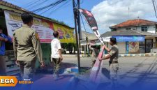 Caption: sikap tegas, petugas Satpol PP Sumenep tampak menurunkan spanduk yang tidak sesuai penempatannya, (sumber foto. Media Center Sumenep). 